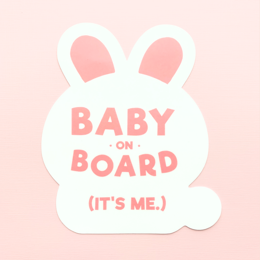 A white bunny sticker with pink text reading "Baby on Board (It's Me)" on a pink background.