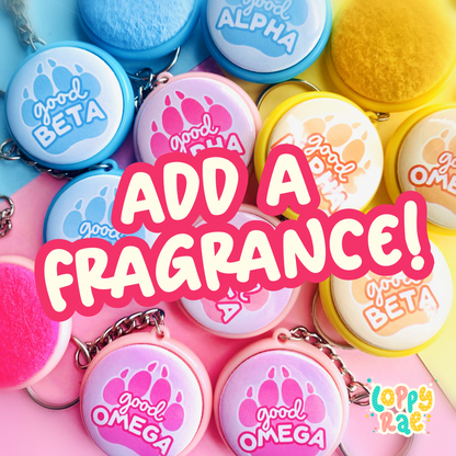 A collection of colorful button-shaped keychains with various fragrances, displayed with the text 'ADD A FRAGRANCE!' prominently shown.
